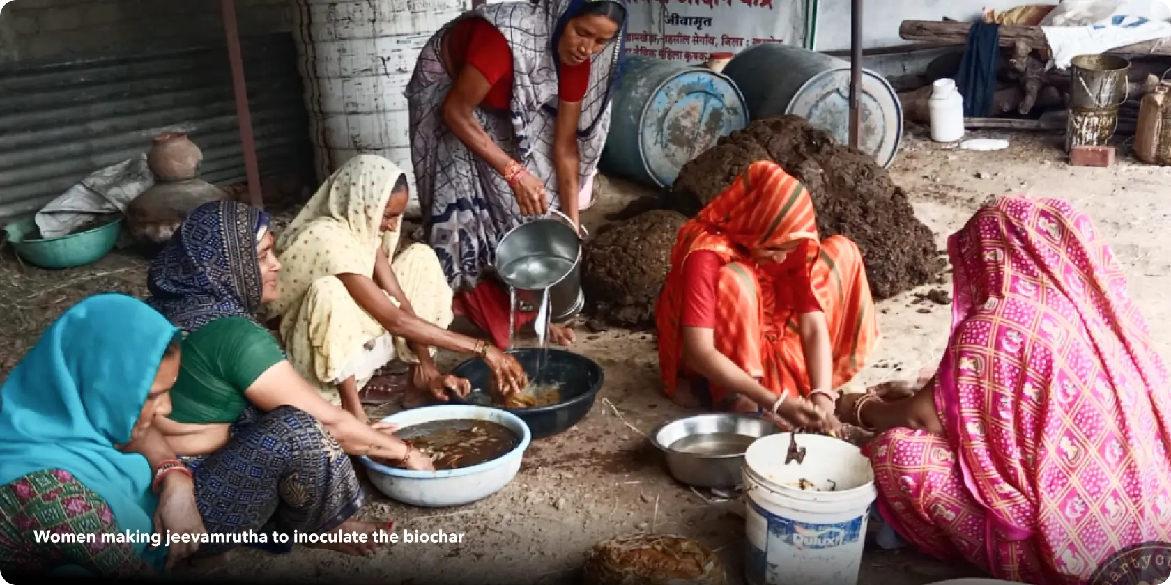 Women making jeevamrutha to inoculate the biochar